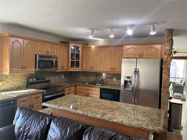 897 NW 97th Ave, Plantation, FL 33324 - kitchen featuring appliances with stainless steel finishes, a sink, glass insert cabinets, decorative backsplash, and a textured ceiling