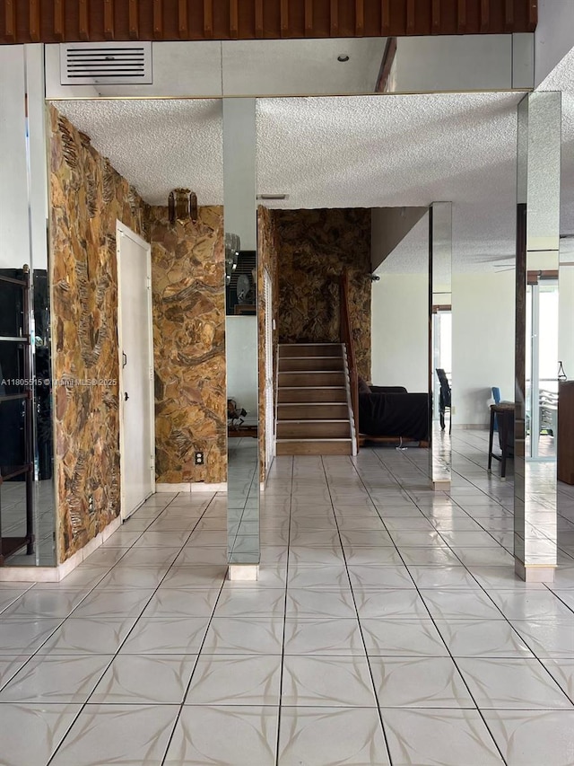 897 NW 97th Ave, Plantation, FL 33324 - unfurnished room with a textured ceiling, stairway, and light tile patterned floors