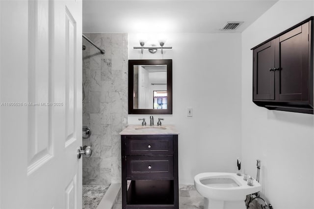 bathroom with marble finish floors, a shower, vanity, and a bidet