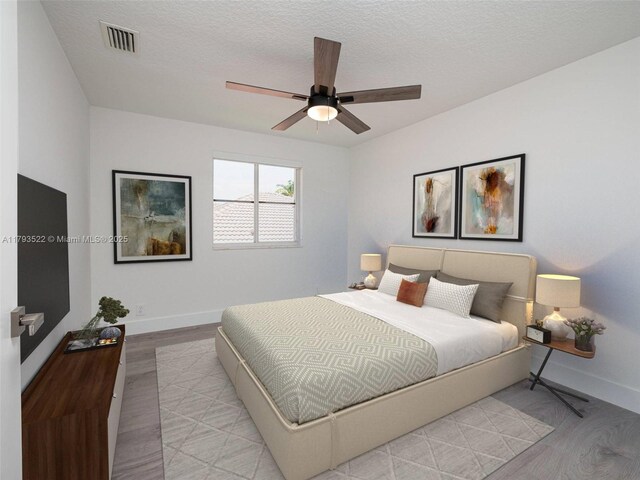 1128 Hidden Valley Way, Weston, FL 33327 - bedroom with light wood-style flooring, baseboards, a ceiling fan, and a textured ceiling