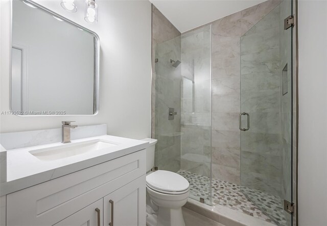 1128 Hidden Valley Way, Weston, FL 33327 - bathroom featuring a shower stall, vanity, and toilet