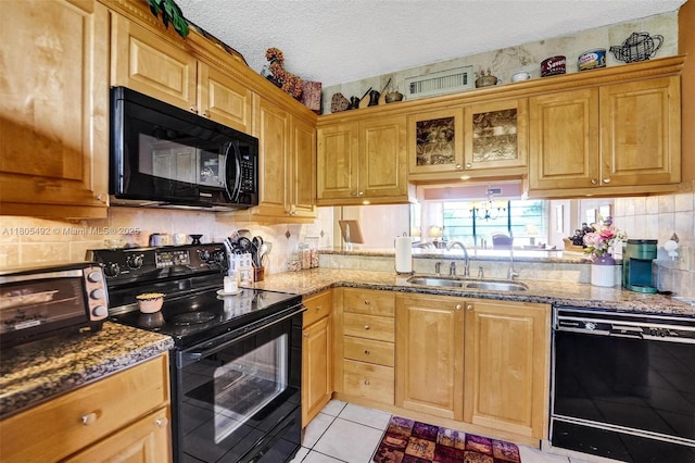 1510 Whitehall Dr Unit 402, Davie, FL 33324 - kitchen featuring black appliances, light stone countertops, tasteful backsplash, a textured ceiling, and light tile patterned floors