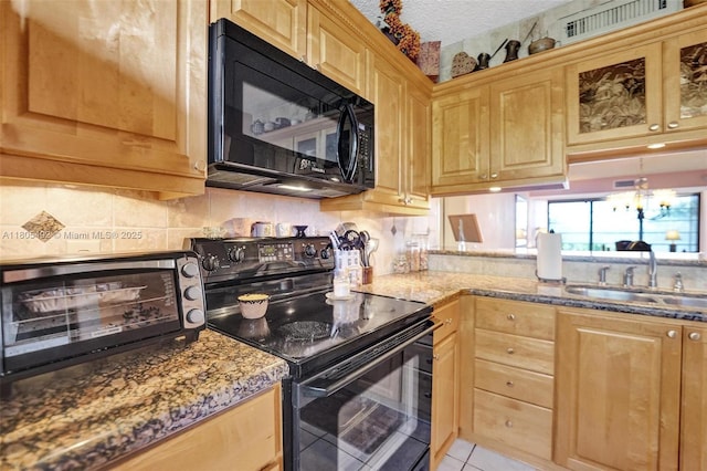 1510 Whitehall Dr Unit 402, Davie, FL 33324 - kitchen with black appliances, tasteful backsplash, stone countertops, and light brown cabinets