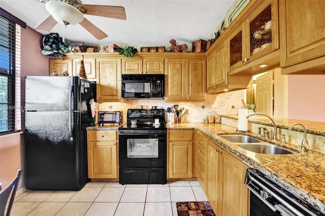1510 Whitehall Dr Unit 402, Davie, FL 33324 - kitchen featuring black appliances, a sink, a ceiling fan, light tile patterned flooring, and glass insert cabinets