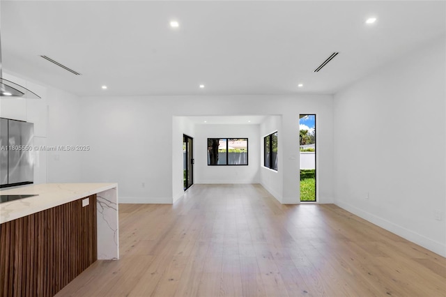 53 NW 107th St, Miami Shores, FL 33168 - unfurnished living room with recessed lighting and light wood-style floors