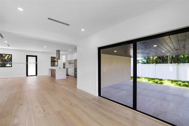 53 NW 107th St, Miami Shores, FL 33168 - unfurnished living room with healthy amount of natural light, light wood-type flooring, and recessed lighting