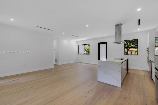 53 NW 107th St, Miami Shores, FL 33168 - kitchen featuring island range hood, light stone countertops, electric stovetop, light wood-style flooring, and recessed lighting