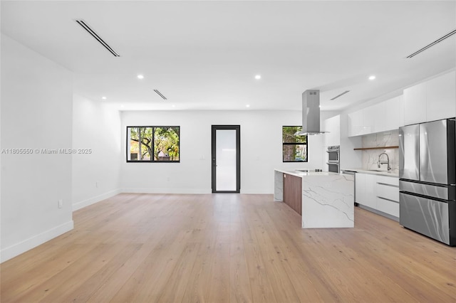 53 NW 107th St, Miami Shores, FL 33168 - kitchen with stainless steel appliances, modern cabinets, a kitchen island, white cabinets, and recessed lighting