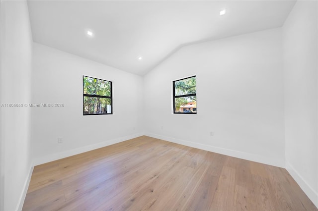 53 NW 107th St, Miami Shores, FL 33168 - unfurnished room with light wood finished floors, vaulted ceiling, and recessed lighting