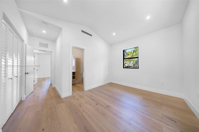 53 NW 107th St, Miami Shores, FL 33168 - unfurnished bedroom with lofted ceiling, light wood-style floors, and recessed lighting