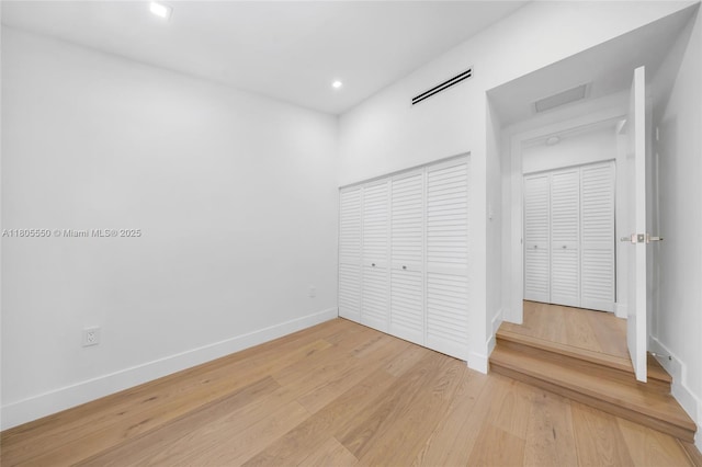 53 NW 107th St, Miami Shores, FL 33168 - unfurnished bedroom with a closet, light wood-style floors, and recessed lighting