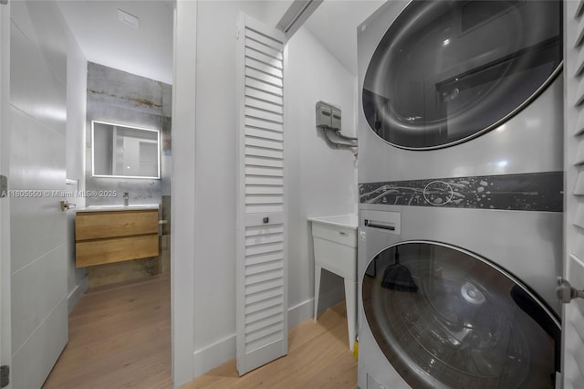 53 NW 107th St, Miami Shores, FL 33168 - laundry area featuring stacked washer / drying machine and light wood-style floors