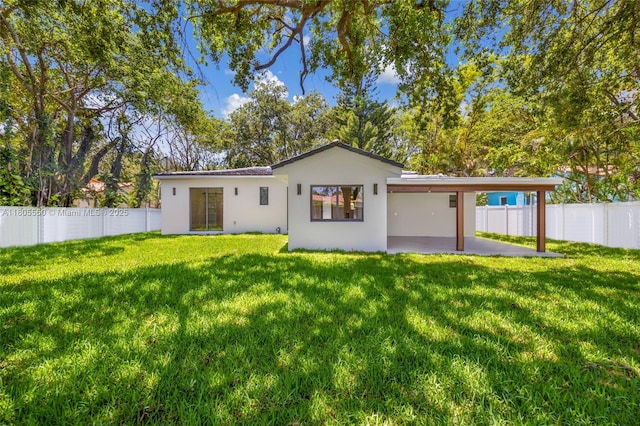 53 NW 107th St, Miami Shores, FL 33168 - rear view of house featuring stucco siding, a patio area, and a fenced backyard