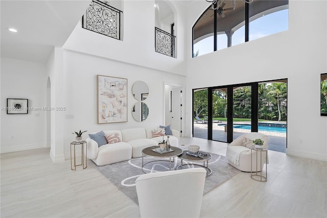 11930 NW 8th St, Plantation, FL 33325 - living room featuring arched walkways, plenty of natural light, a towering ceiling, french doors, and baseboards