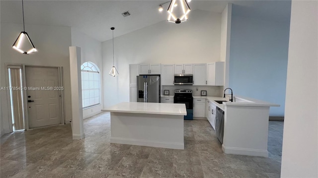 2615 Spiceberry Ln Unit 2625, Boynton Beach, FL 33436 - kitchen featuring stainless steel appliances, high vaulted ceiling, light countertops, a center island, and pendant lighting