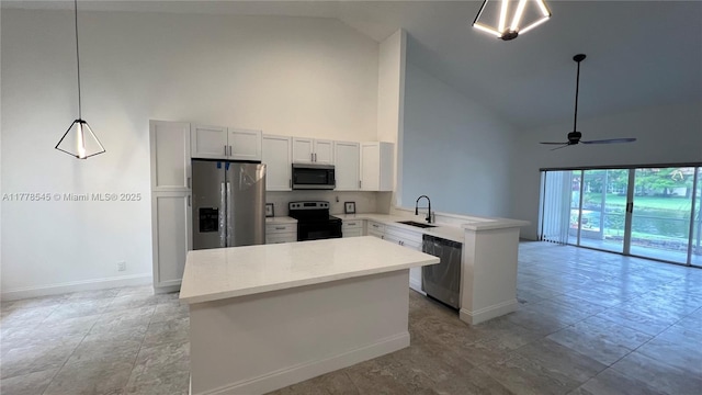 2615 Spiceberry Ln Unit 2625, Boynton Beach, FL 33436 - kitchen with stainless steel appliances, high vaulted ceiling, a peninsula, light countertops, and a ceiling fan