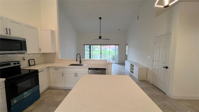 2615 Spiceberry Ln Unit 2625, Boynton Beach, FL 33436 - kitchen featuring appliances with stainless steel finishes, high vaulted ceiling, light countertops, white cabinetry, and a ceiling fan