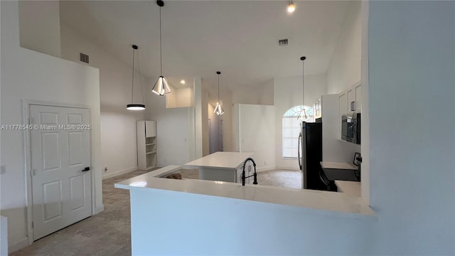 2615 Spiceberry Ln Unit 2625, Boynton Beach, FL 33436 - kitchen with black / electric stove, freestanding refrigerator, high vaulted ceiling, light countertops, and white cabinetry