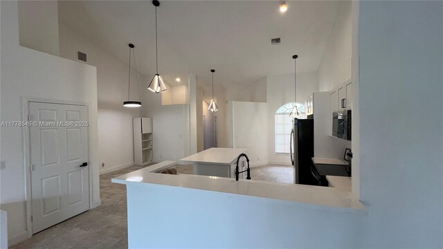2615 Spiceberry Ln Unit 2625, Boynton Beach, FL 33436 - kitchen featuring appliances with stainless steel finishes, high vaulted ceiling, light countertops, white cabinetry, and a center island