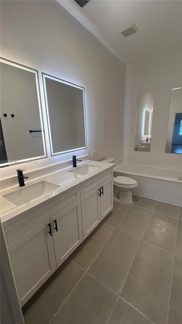 2615 Spiceberry Ln Unit 2625, Boynton Beach, FL 33436 - bathroom featuring tile patterned floors, double vanity, and a bathtub
