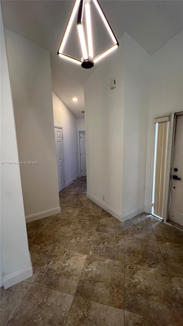2615 Spiceberry Ln Unit 2625, Boynton Beach, FL 33436 - unfurnished room featuring vaulted ceiling and baseboards