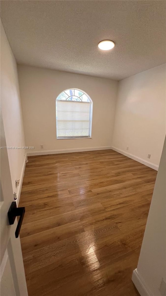 2615 Spiceberry Ln Unit 2625, Boynton Beach, FL 33436 - empty room with wood finished floors and a textured ceiling