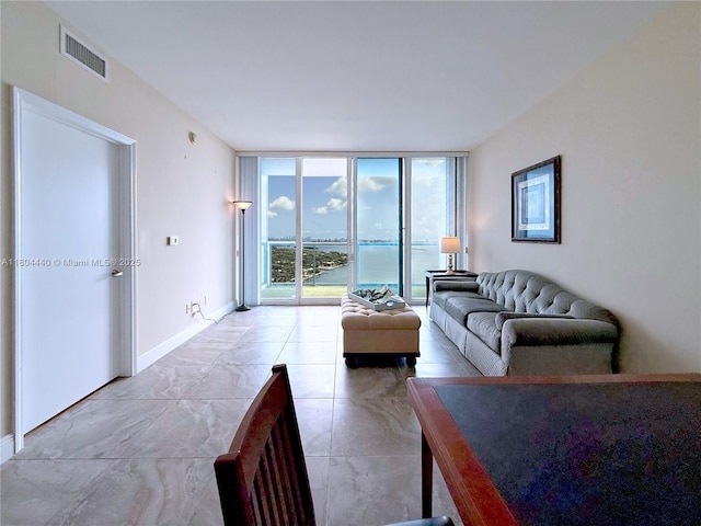 601 NE 36th St Unit 2608, Miami, FL 33137 - living room featuring expansive windows, baseboards, and a water view