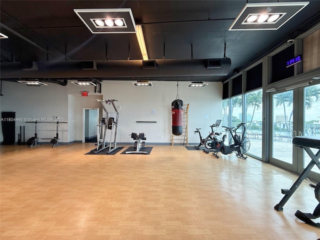 601 NE 36th St Unit 2608, Miami, FL 33137 - workout area with light wood-type flooring and baseboards