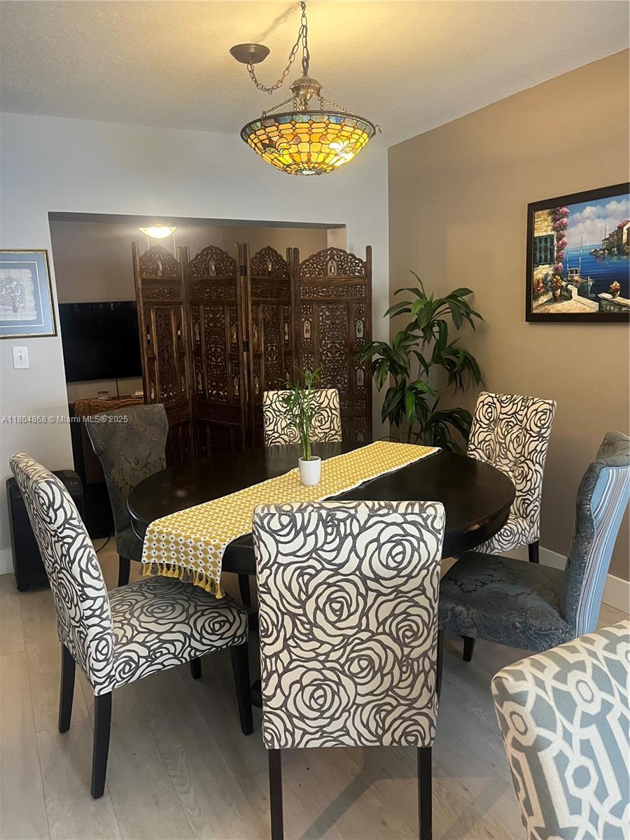 3901 SW 153rd Ct, Miami, FL 33185 - dining area featuring wood finished floors and baseboards