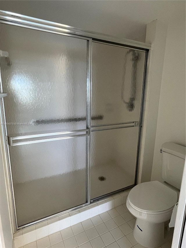 2520 SE 19th Pl Unit 202-B, Homestead, FL 33035 - full bathroom with toilet, tile patterned floors, and a shower stall