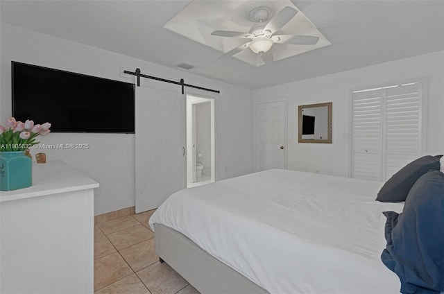 16401 SW 94th St, Miami, FL 33196 - bedroom featuring a barn door, light tile patterned flooring, and a ceiling fan