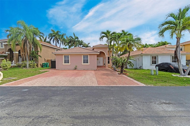 16401 SW 94th St, Miami, FL 33196 - mediterranean / spanish-style home with stucco siding, a tiled roof, a front lawn, and driveway