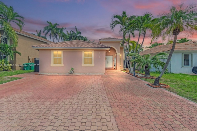 16401 SW 94th St, Miami, FL 33196 - mediterranean / spanish home with stucco siding, a tile roof, decorative driveway, and a lawn