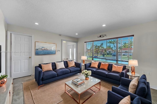 9875 SW 26th Ter, Miami, FL 33165 - living area featuring recessed lighting, a textured ceiling, and concrete flooring