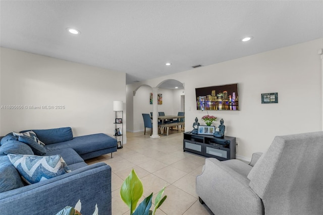 9875 SW 26th Ter, Miami, FL 33165 - living area with arched walkways, recessed lighting, light tile patterned floors, and baseboards