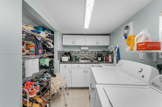 9875 SW 26th Ter, Miami, FL 33165 - washroom featuring washing machine and clothes dryer, light tile patterned floors, and cabinet space
