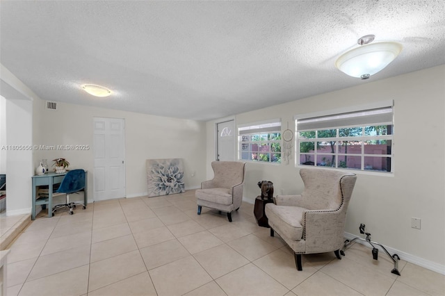9875 SW 26th Ter, Miami, FL 33165 - sitting room featuring a textured ceiling, tile patterned flooring, and baseboards