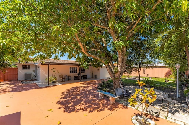 9875 SW 26th Ter, Miami, FL 33165 - rear view of house with a patio area, a tile roof, and stucco siding