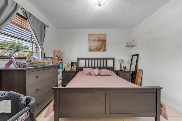 9875 SW 26th Ter, Miami, FL 33165 - bedroom with a textured ceiling, light tile patterned floors, and baseboards
