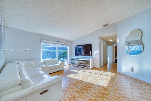 6755 NW 199th St, Hialeah, FL 33015 - living room featuring lofted ceiling, a textured ceiling, and light tile patterned floors