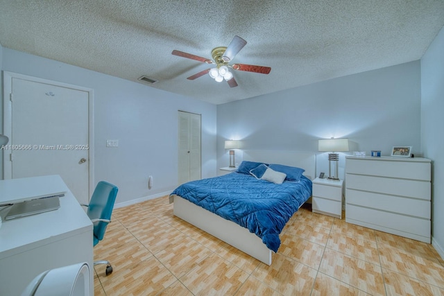 6755 NW 199th St, Hialeah, FL 33015 - bedroom with a closet, a textured ceiling, ceiling fan, light tile patterned floors, and baseboards