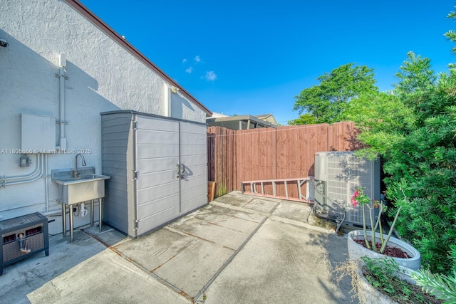 6755 NW 199th St, Hialeah, FL 33015 - view of patio with cooling unit and a sink