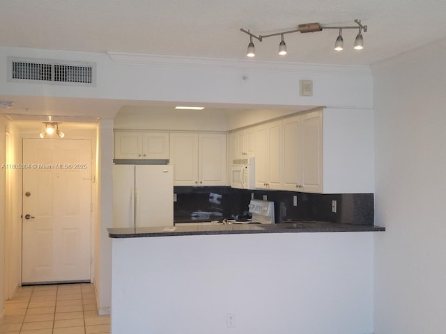 2501 S Ocean Dr Unit 1634, Hollywood, FL 33019 - kitchen with white appliances, dark countertops, white cabinets, light tile patterned floors, and crown molding