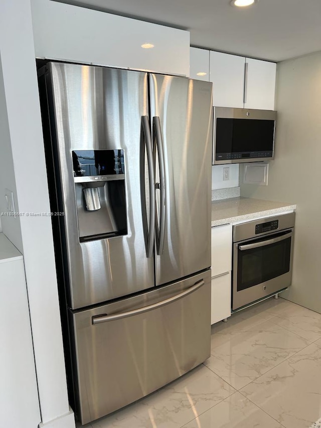 7601 E Treasure Dr Unit 1622, North Bay Village, FL 33141 - kitchen with appliances with stainless steel finishes, light marble finish floors, white cabinets, recessed lighting, and modern cabinets