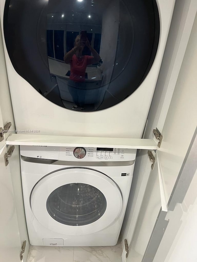 7601 E Treasure Dr Unit 1622, North Bay Village, FL 33141 - laundry area featuring marble finish floors and stacked washing machine and dryer