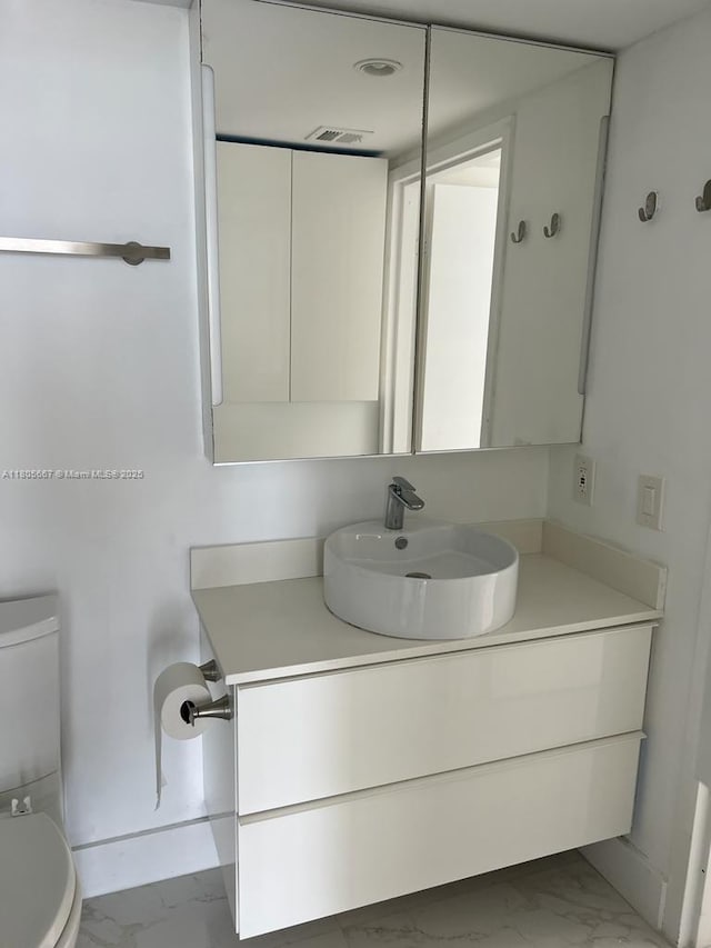 7601 E Treasure Dr Unit 1622, North Bay Village, FL 33141 - half bath featuring marble look tiles, toilet, and vanity