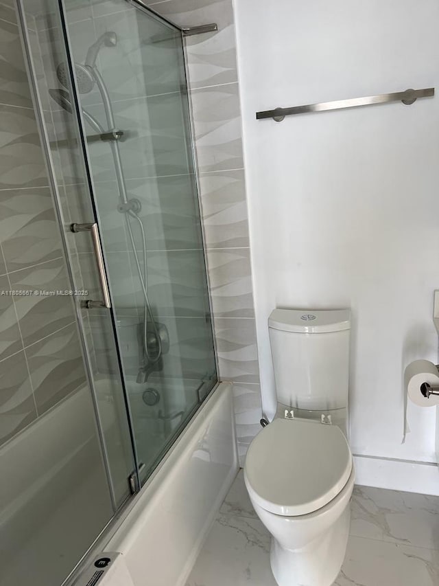 7601 E Treasure Dr Unit 1622, North Bay Village, FL 33141 - full bath featuring marble look tiles, toilet, baseboards, and bath / shower combo with glass door