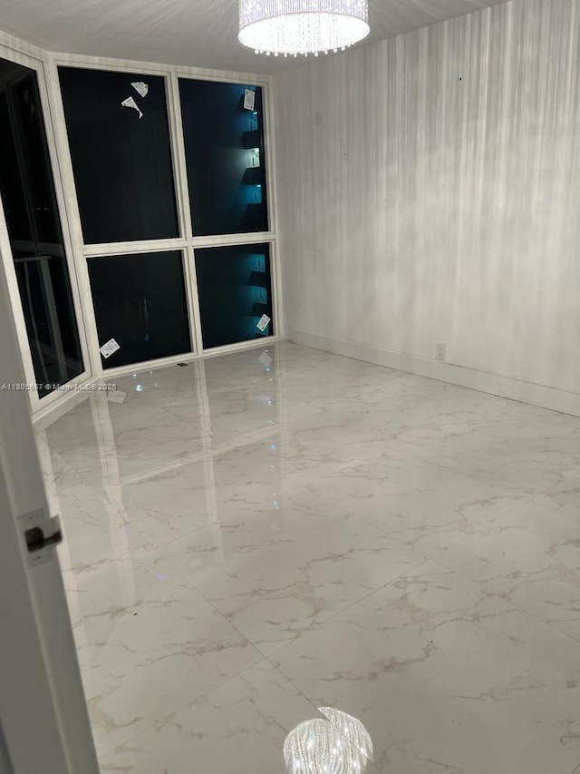 7601 E Treasure Dr Unit 1622, North Bay Village, FL 33141 - empty room with a chandelier and marble finish flooring
