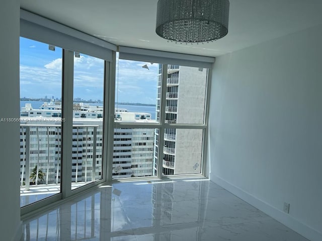 7601 E Treasure Dr Unit 1622, North Bay Village, FL 33141 - empty room with marble finish floors, baseboards, a view of city, and a water view