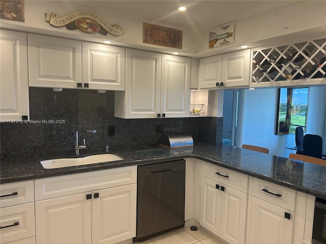 400 Diplomat Pkwy Unit 611, Hallandale Beach, FL 33009 - kitchen with dishwashing machine, a sink, white cabinets, dark stone counters, and tasteful backsplash
